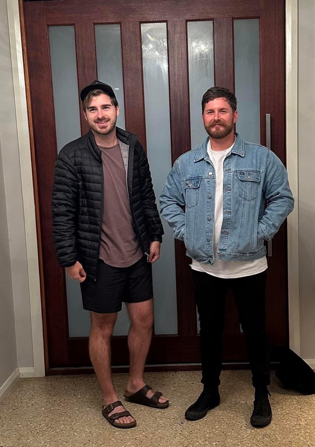 Two brothers standing at a front door
